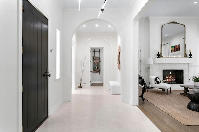 corridor featuring ornamental molding and light wood-type flooring