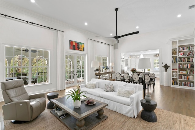 living room featuring french doors, ceiling fan, wood-type flooring, and ornamental molding