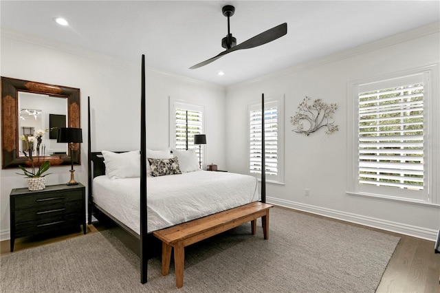 bedroom with ornamental molding, hardwood / wood-style flooring, and ceiling fan