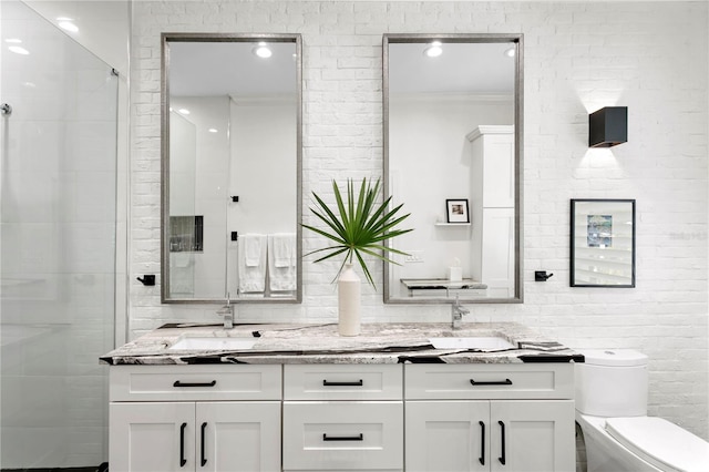 bathroom with walk in shower, toilet, ornamental molding, vanity, and brick wall