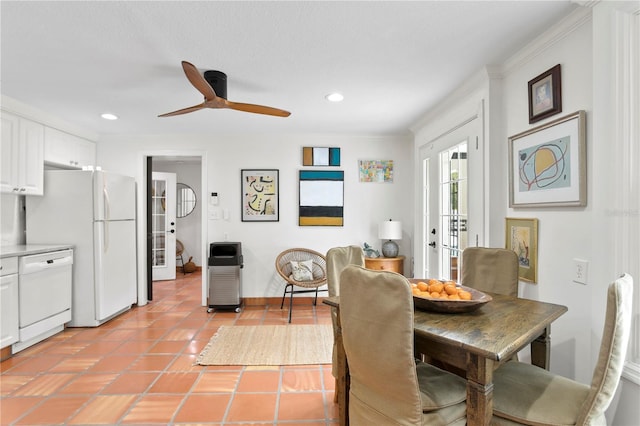 dining space featuring crown molding, light tile patterned flooring, and ceiling fan