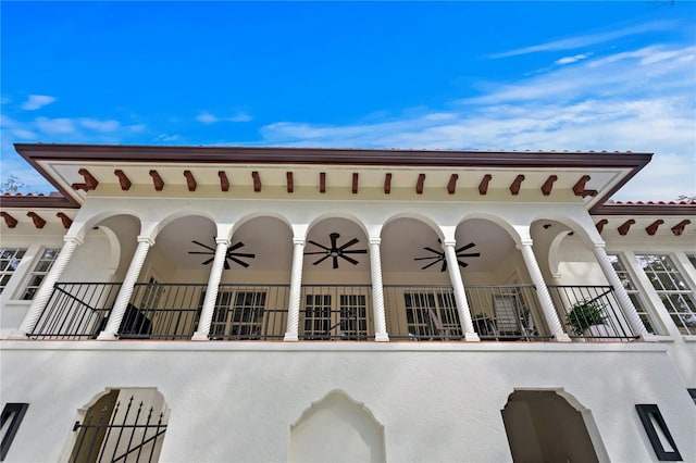 exterior space featuring a balcony and ceiling fan