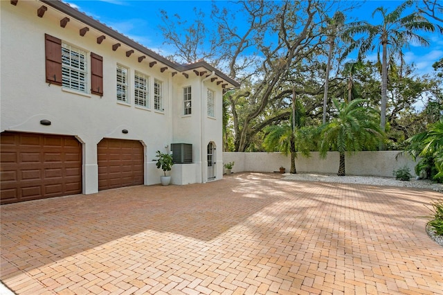 view of side of home featuring a garage