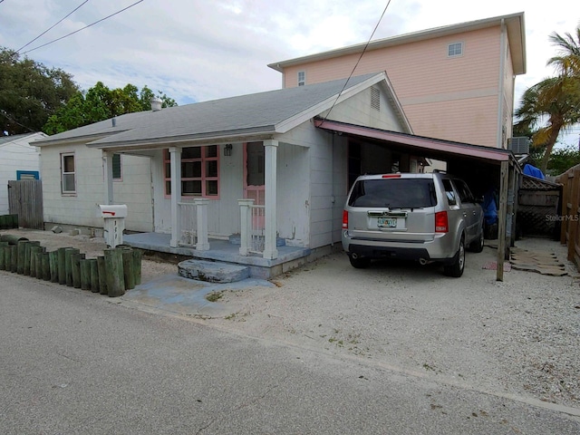 view of front of property featuring covered porch and a carport