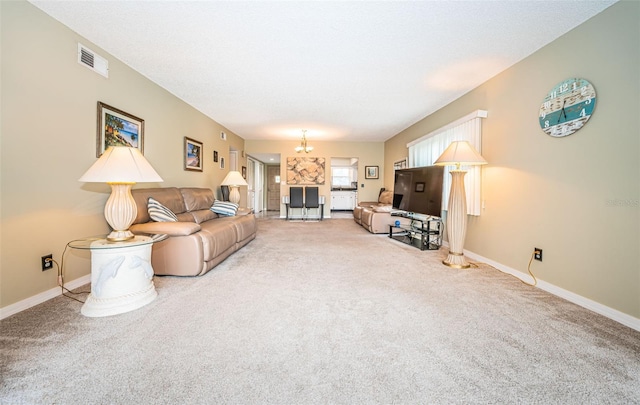 carpeted living room featuring a notable chandelier