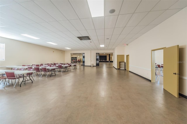 interior space with a drop ceiling and concrete flooring