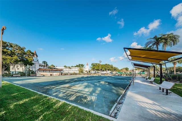 view of home's community featuring basketball court and a yard