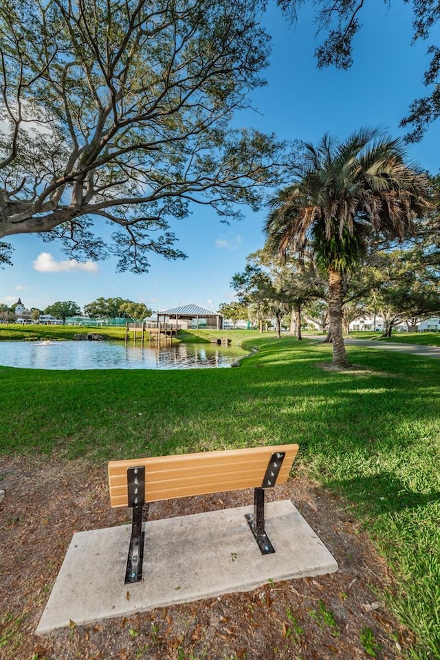 view of property's community with a yard and a water view