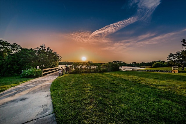 surrounding community featuring a lawn and a rural view