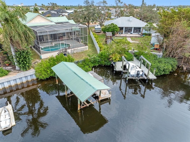 dock area featuring a patio, a water view, and glass enclosure