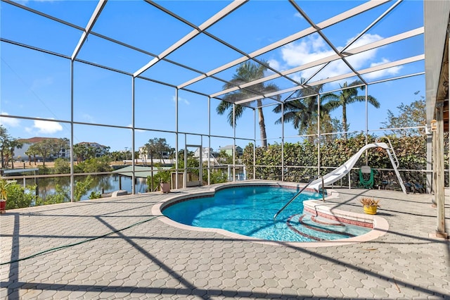 view of pool featuring glass enclosure, a patio area, a water view, and a water slide