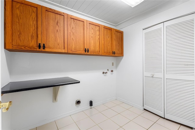 laundry room featuring electric dryer hookup and cabinets