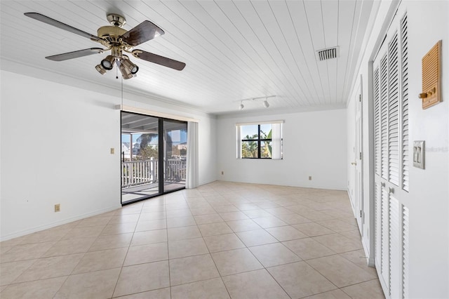 unfurnished room featuring light tile patterned floors, rail lighting, and ceiling fan