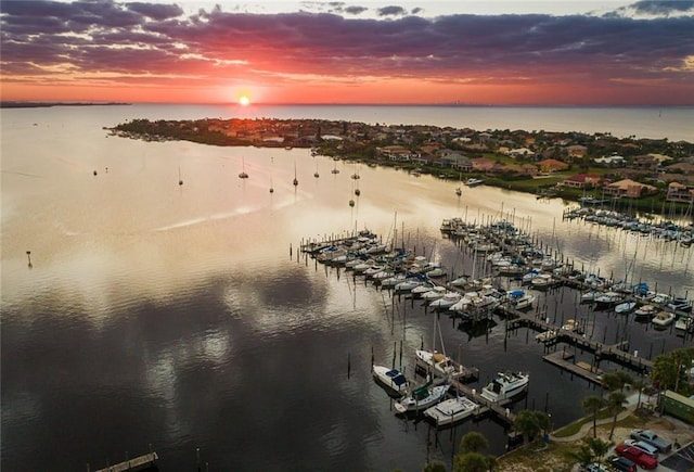 aerial view at dusk featuring a water view