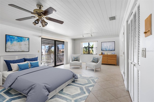 bedroom featuring light tile patterned floors, visible vents, access to exterior, rail lighting, and crown molding