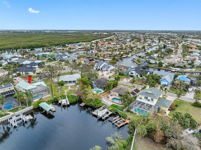 birds eye view of property with a water view and a residential view