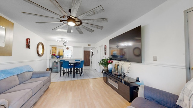 living room with light wood-type flooring and ceiling fan