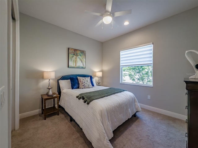 bedroom featuring ceiling fan and light colored carpet