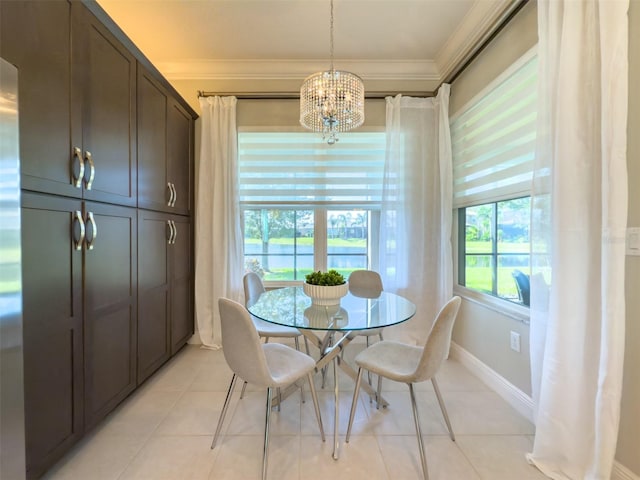 dining space with a notable chandelier, ornamental molding, and light tile patterned floors