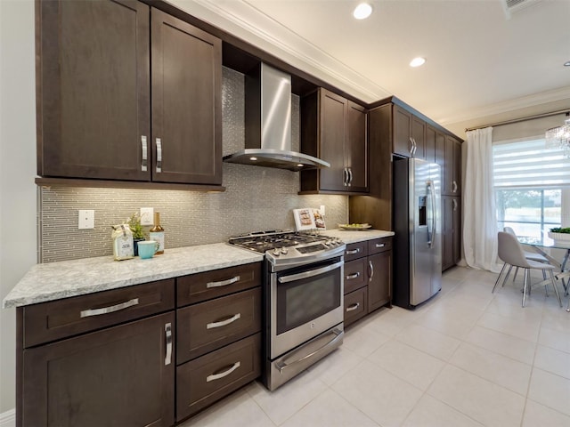 kitchen with stainless steel appliances, wall chimney range hood, dark brown cabinets, and crown molding