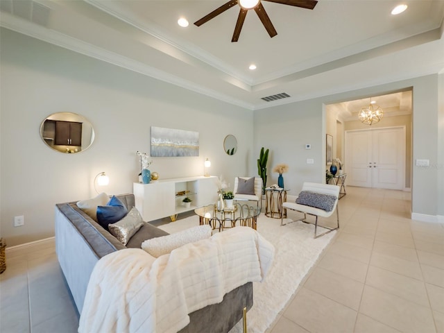 tiled living room with ceiling fan with notable chandelier, a raised ceiling, and crown molding