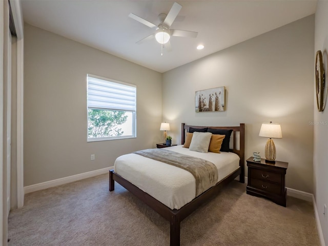 bedroom with ceiling fan and light colored carpet