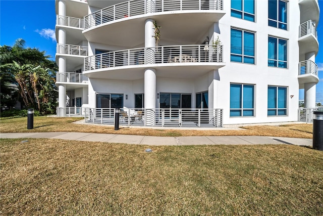 exterior space with a balcony and a yard