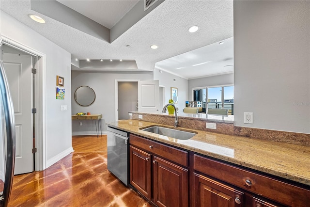 kitchen with a textured ceiling, sink, light stone counters, and dishwasher