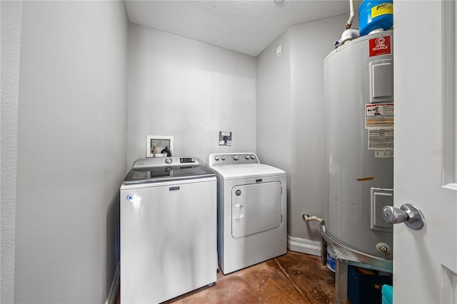 laundry room featuring washing machine and clothes dryer, a textured ceiling, and electric water heater