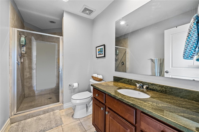 bathroom featuring vanity, a shower with shower door, tile patterned flooring, and toilet