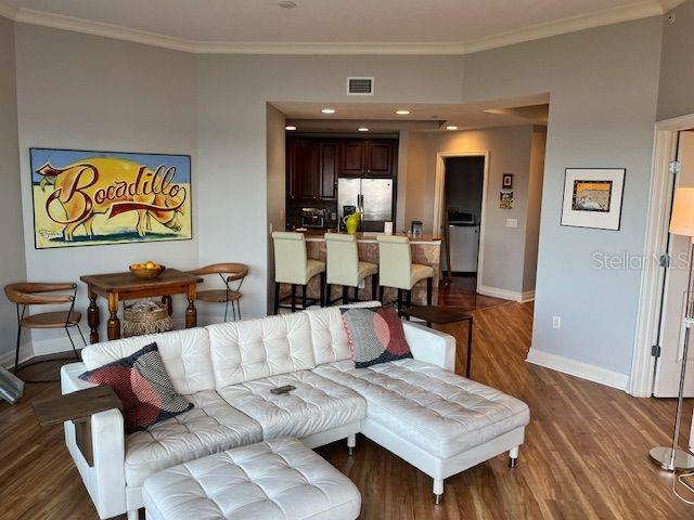 1209 E Cumberland Ave Unit 508, Tampa, FL 33602 - living area featuring baseboards, ornamental molding, and wood finished floors