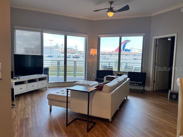 1209 E Cumberland Ave Unit 508, Tampa, FL 33602 - living room featuring ornamental molding, wood finished floors, and ceiling fan