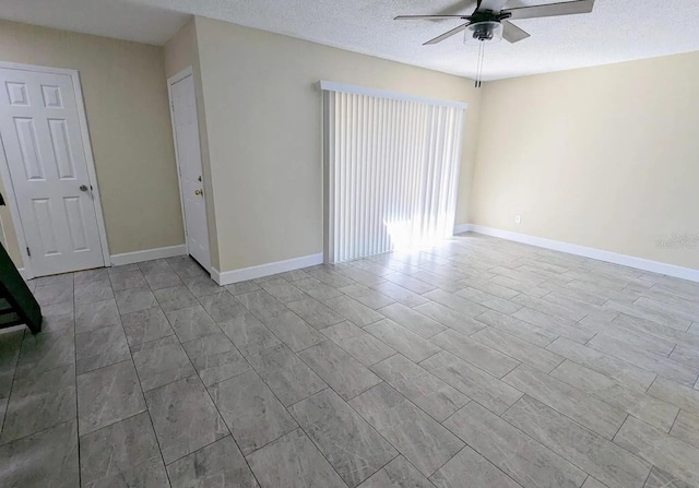 spare room featuring a textured ceiling and ceiling fan