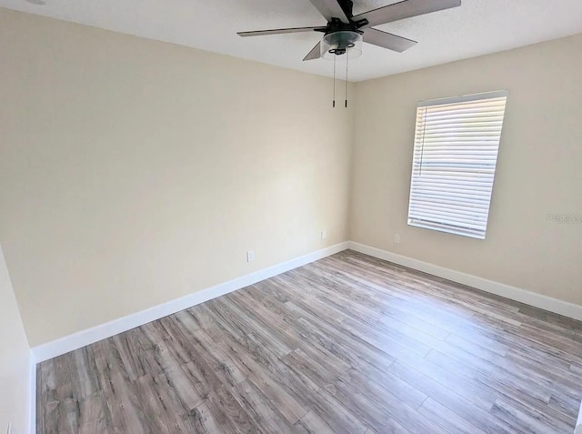 empty room featuring light wood-type flooring and ceiling fan