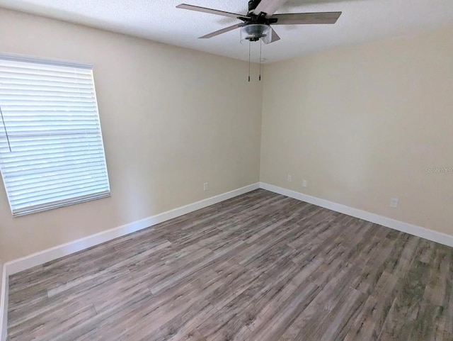 empty room featuring wood-type flooring and ceiling fan