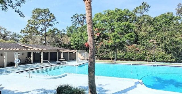 view of pool with a patio and a pergola