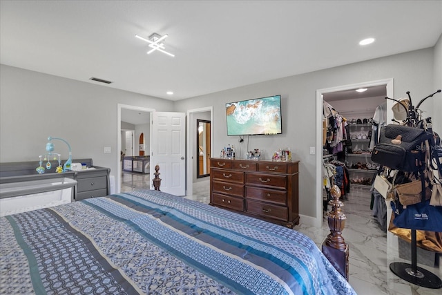 bedroom with a walk in closet and a closet