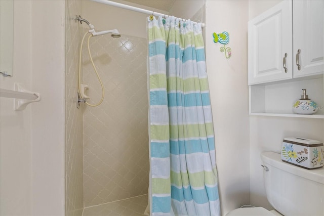 bathroom featuring toilet and walk in shower