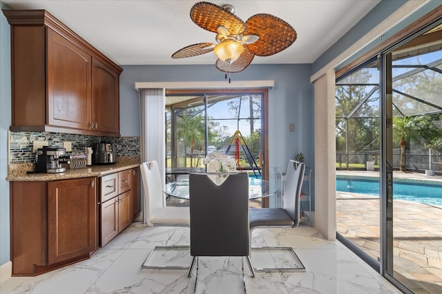 dining room with a wealth of natural light and ceiling fan