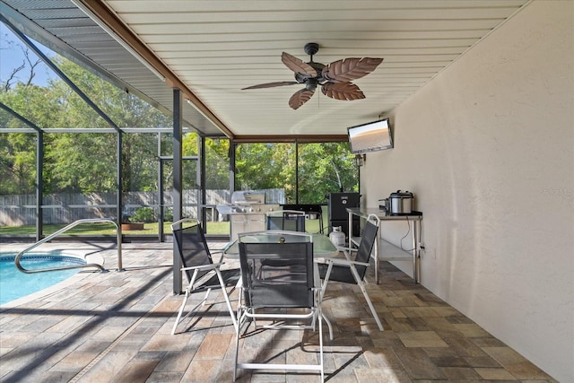 sunroom / solarium featuring ceiling fan