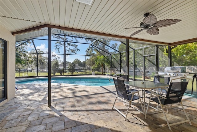 view of swimming pool featuring a patio area, a lanai, and ceiling fan