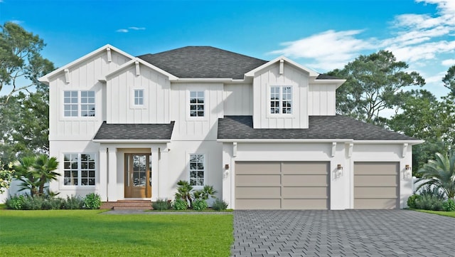 view of front of house featuring a front yard and a garage