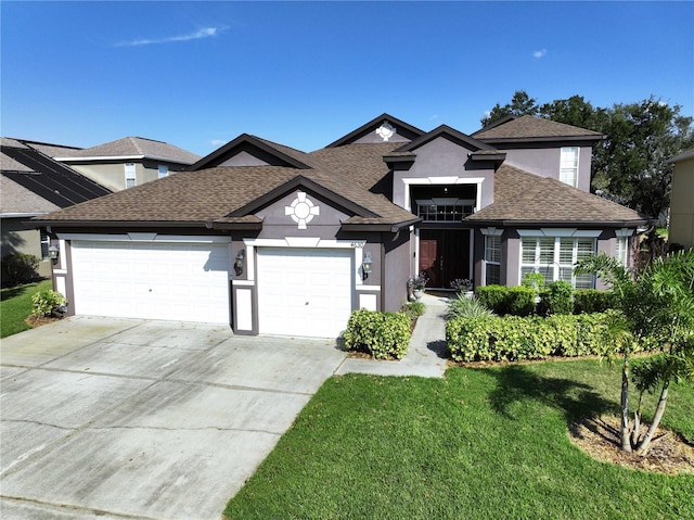 view of front facade with a front yard and a garage