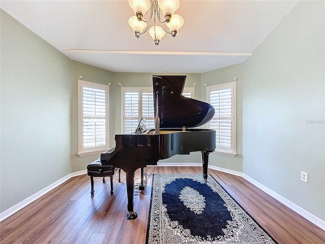 misc room featuring a notable chandelier, hardwood / wood-style flooring, and plenty of natural light