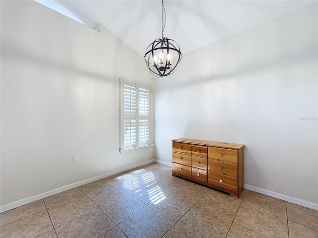 spare room with lofted ceiling, a chandelier, and light tile patterned flooring