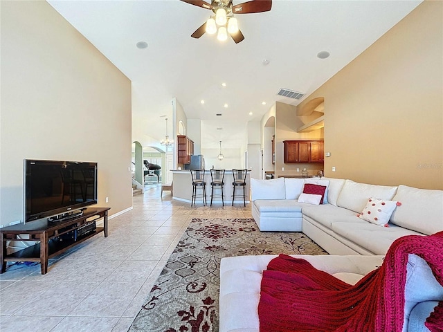 tiled living room with ceiling fan