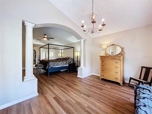 bedroom with lofted ceiling, an inviting chandelier, and dark hardwood / wood-style flooring