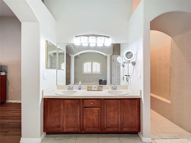 bathroom featuring vanity, walk in shower, ornate columns, and tile patterned flooring