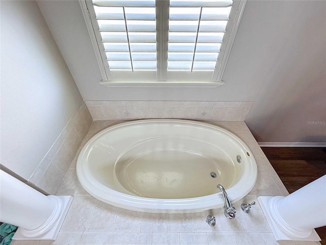 bathroom with a relaxing tiled tub