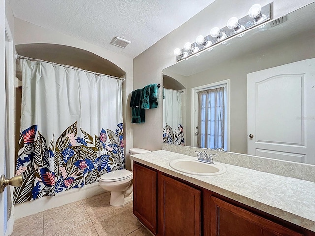 full bathroom with a textured ceiling, shower / bath combination with curtain, toilet, vanity, and tile patterned flooring